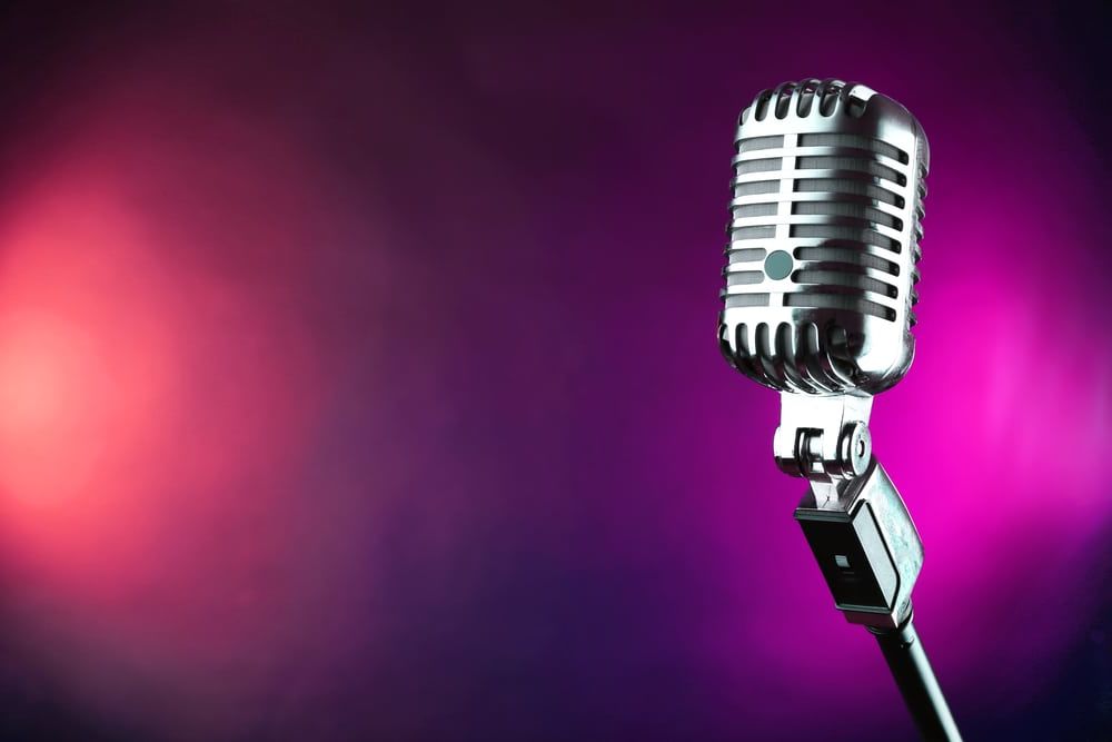 Retro microphone on colorful blurred background
