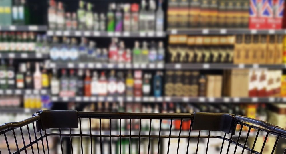 Abstract blurred image of alcohol store with trolley (Selective