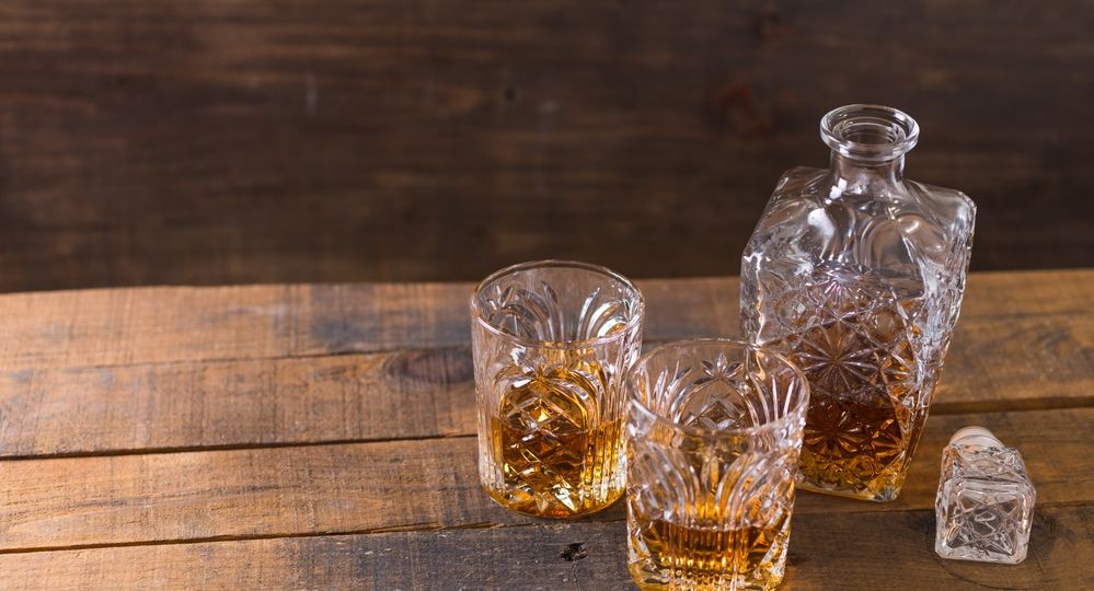 whiskey in glass on wood background