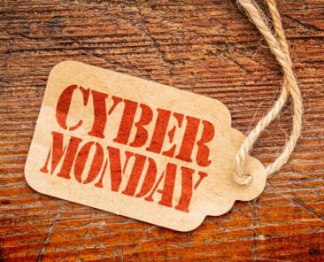 Cyber Monday sign - a paper price tag against rustic red painted barn wood