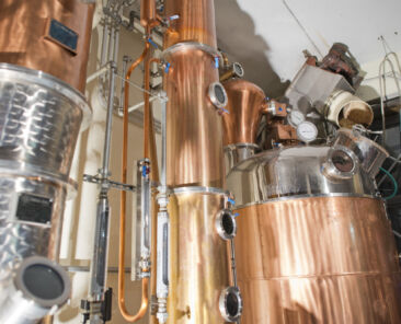 Copper still alembic inside distillery to distill grapes and produce spirits